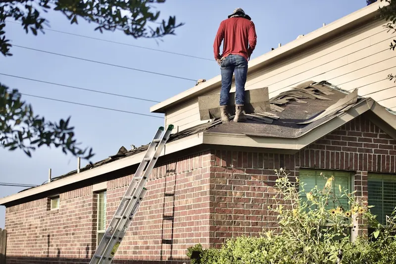 Professional roofer working on a residential roof in Copp Landing